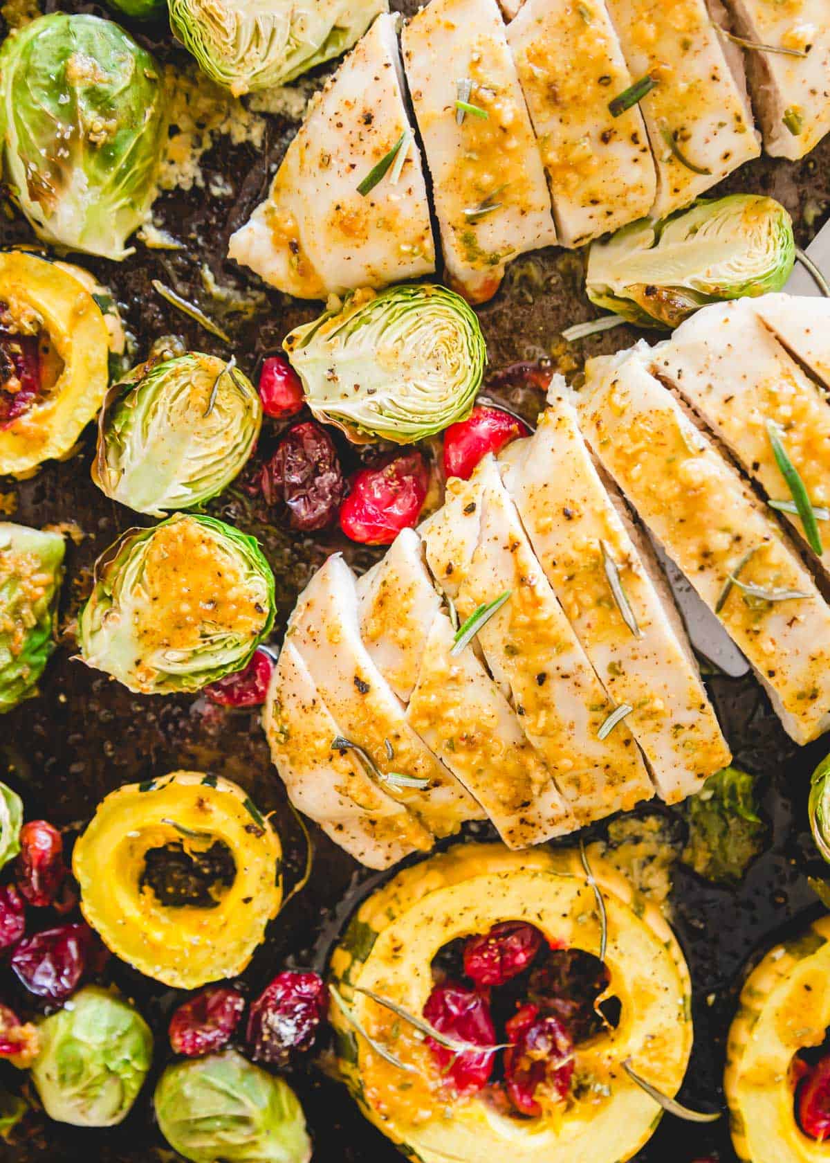 This sheet pan fall chicken dinner included Brussels sprouts, squash and cranberries with a maple mustard sauce.