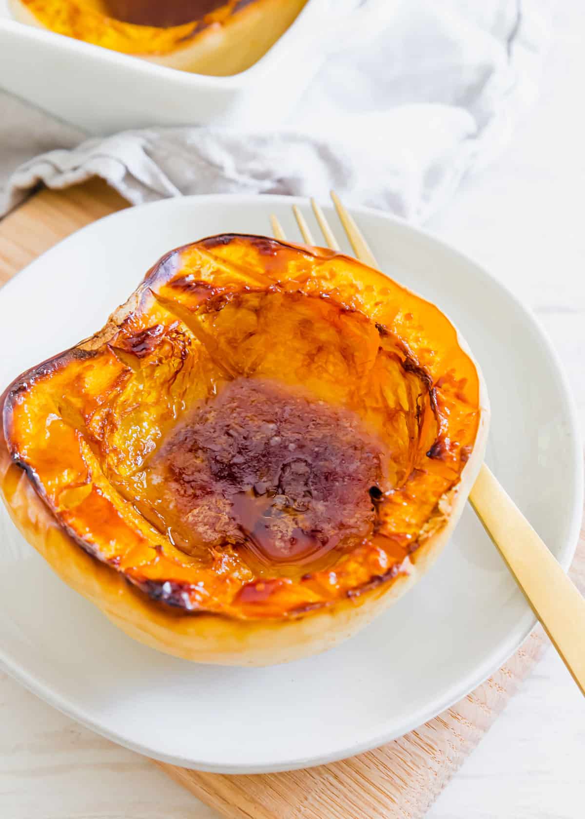 White acorn squash is halved and then baked with maple syrup, butter and sugar for a deliciously easy fall inspired side dish. The perfect combination of savory and sweet!