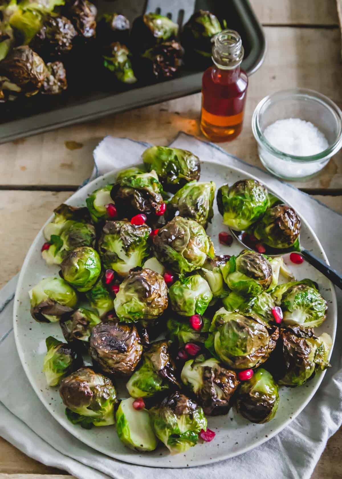 Brussels sprouts roasted on the stalk then cut off and plated with maple balsamic glaze.