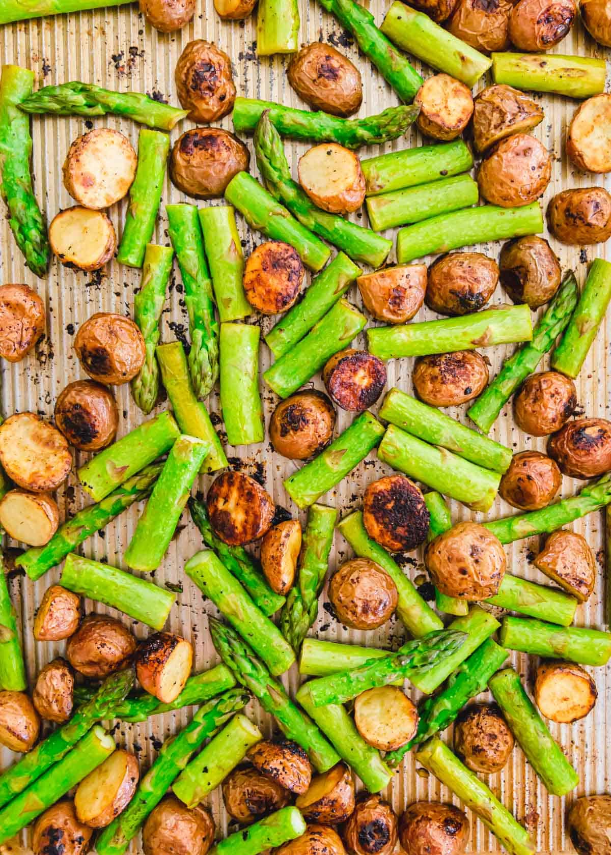 sheet pan roasted red potatoes and asparagus with balsamic and garlic seasoning.