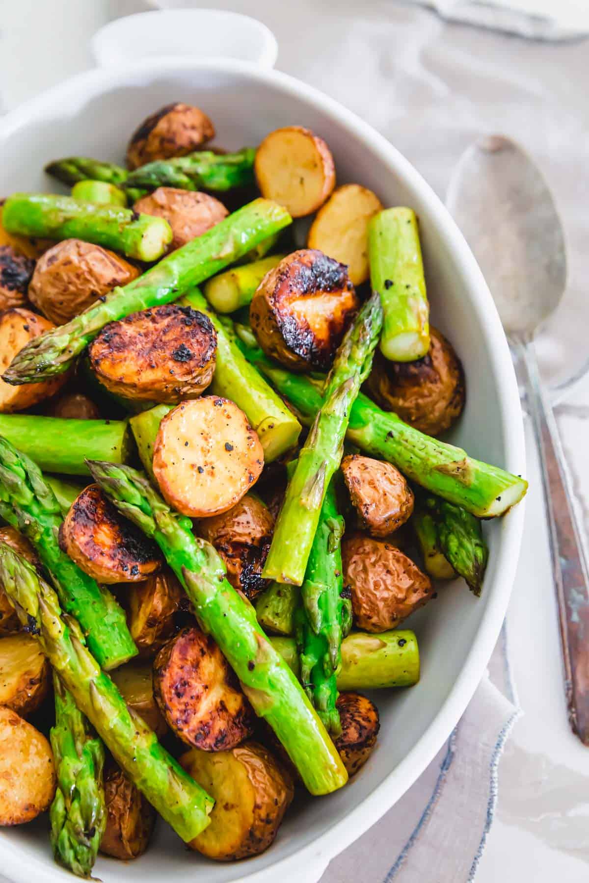 Garlic balsamic roasted potatoes in a white oval dish.