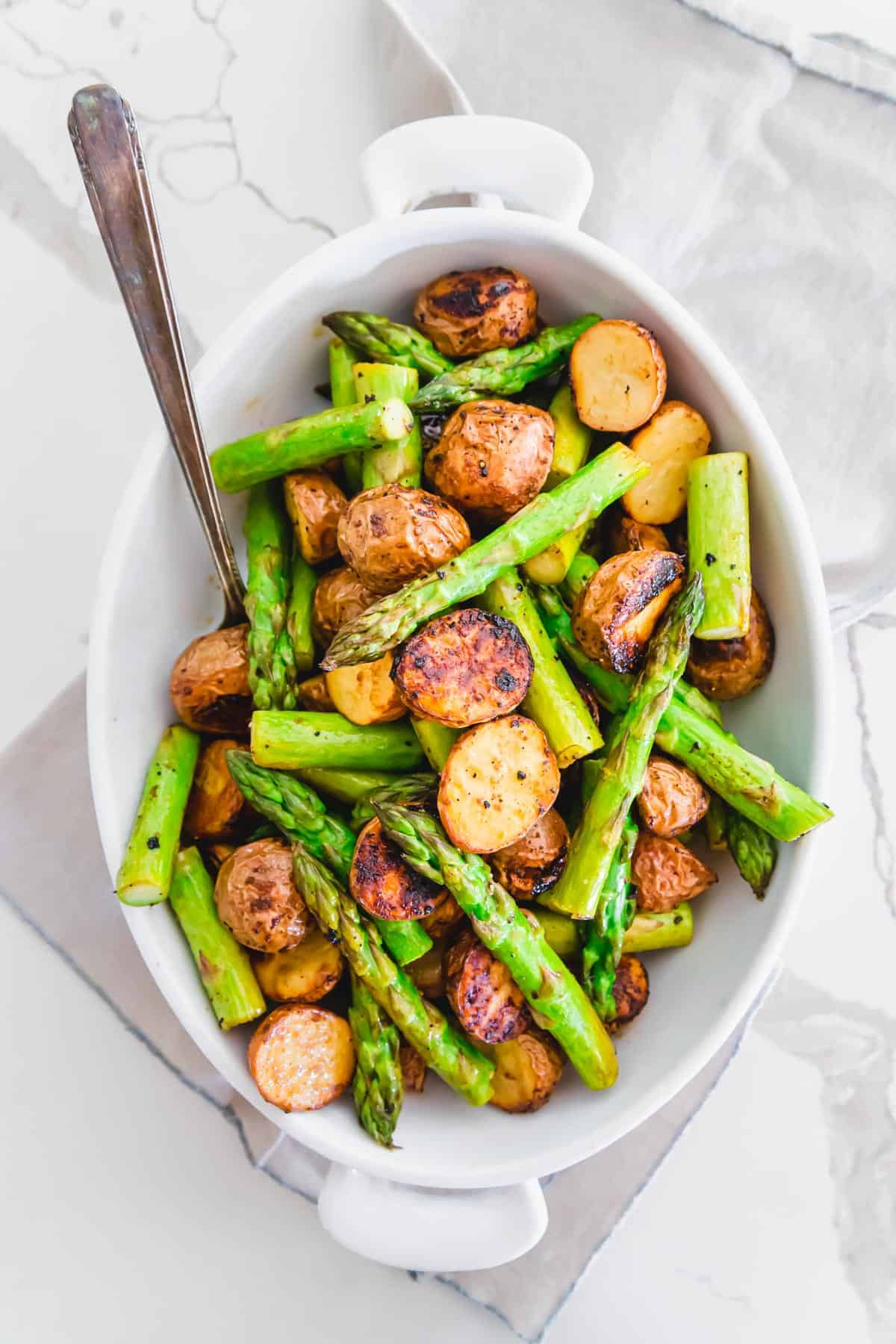 An easy side dish recipe of roasted potatoes and tender crisp asparagus with balsamic vinegar and garlic seasoning.