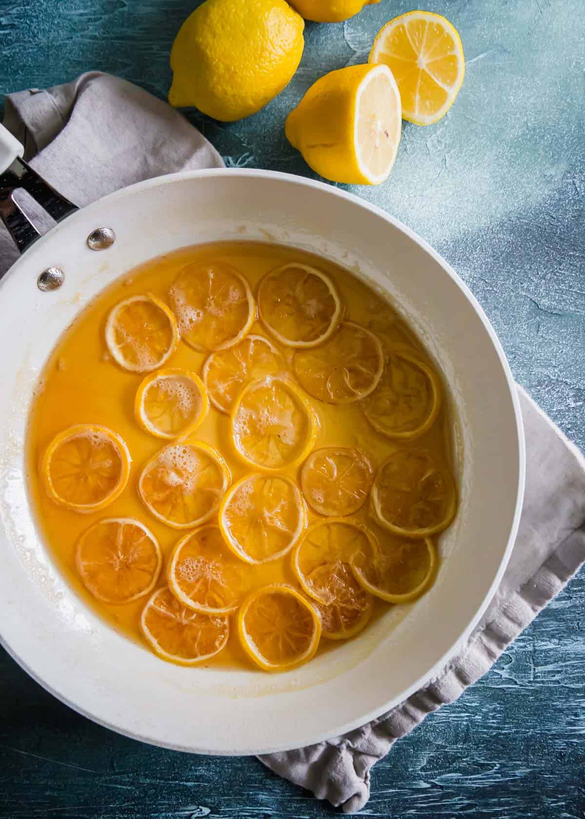 Making candied lemon slices in simple syrup on the stove top