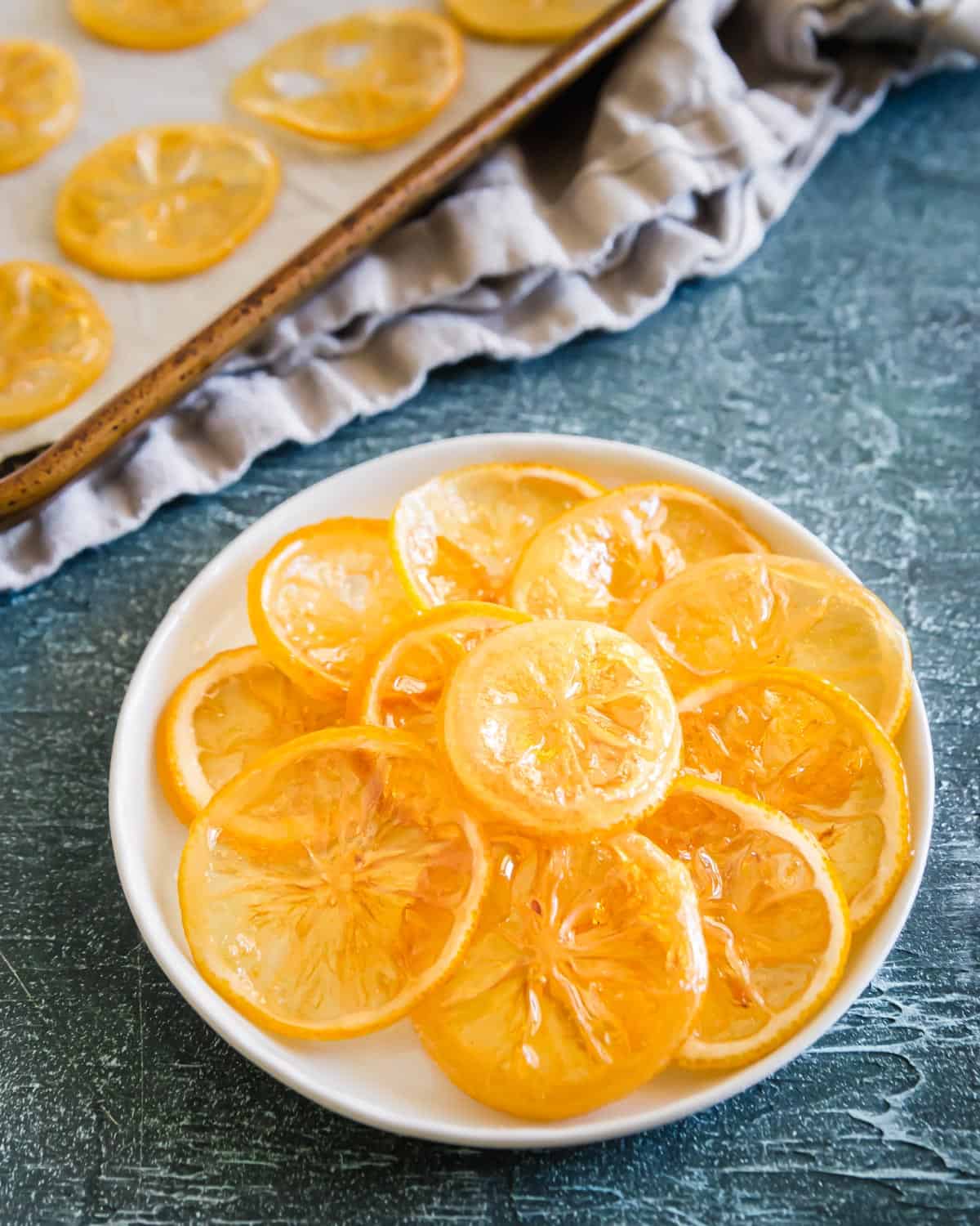 Sweet and tart candied lemon slices are the perfect dessert garnish or addition to festive baking recipes.