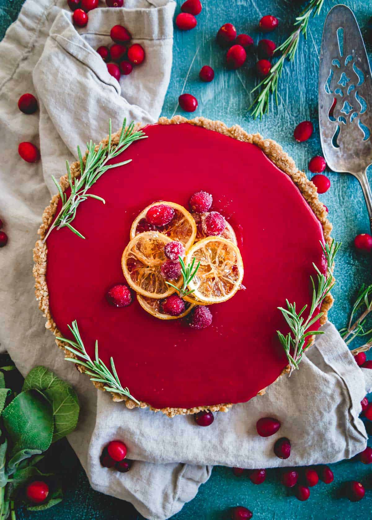 This cranberry curd tart features a smooth sweet and tart cranberry curd filling inside a gluten-free oat and nut-based crust that results in a stunningly delicious and festive holiday dessert.