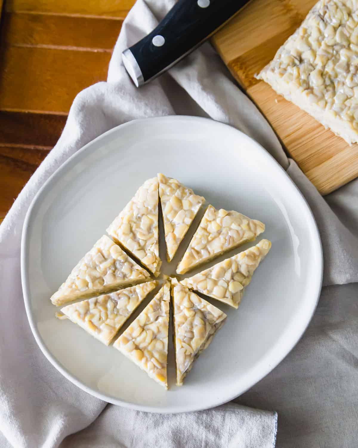 Raw tempeh cut into triangles before marinating.