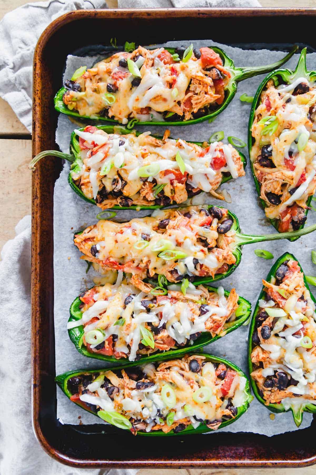 Cheesy baked stuffed poblano peppers with chicken, black beans, tomatoes and Mexican spices.