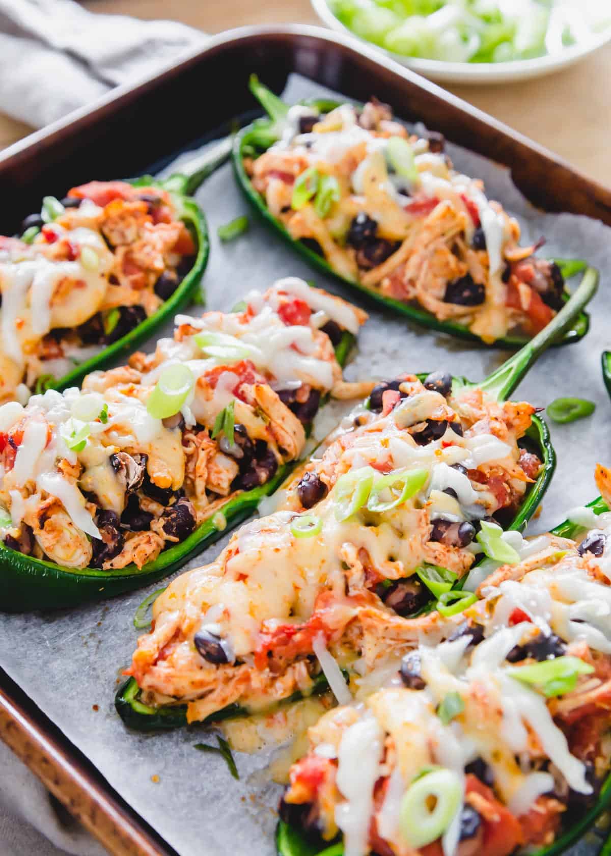 Chicken stuffed poblano peppers are an easy, comforting, low-carb and decadent meal with a Southwestern/Mexican vibe.