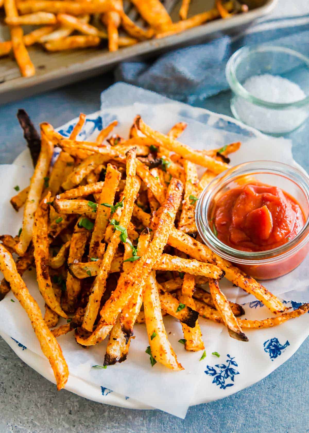 These thin cut jicama fries bake up easily in the oven with the perfect crispy fry texture.