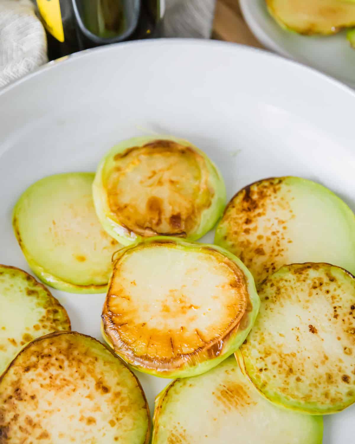 Quickly browning the raw kohlrabi in a pan on the stove top gives it a golden brown caramelized exterior before it roasts in the oven.