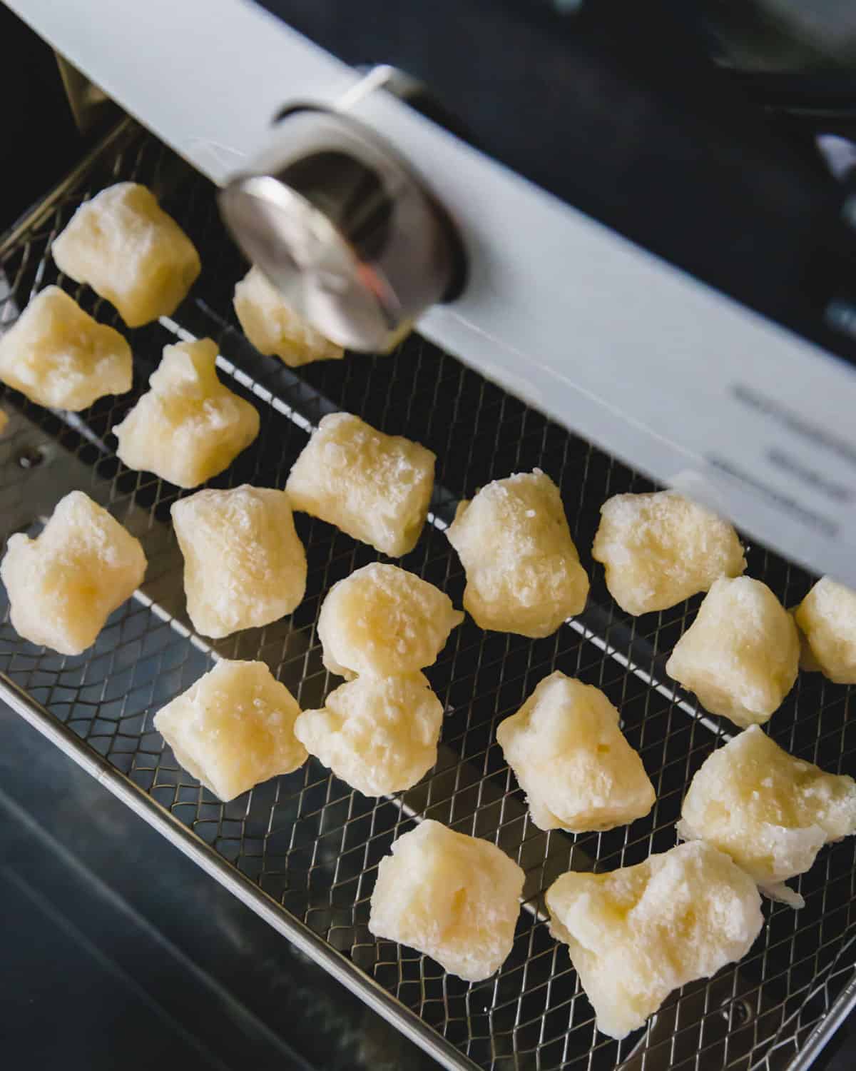 Frozen cauliflower gnocchi is cooked in the air fryer from a frozen state at 400 degrees for 18 minutes.