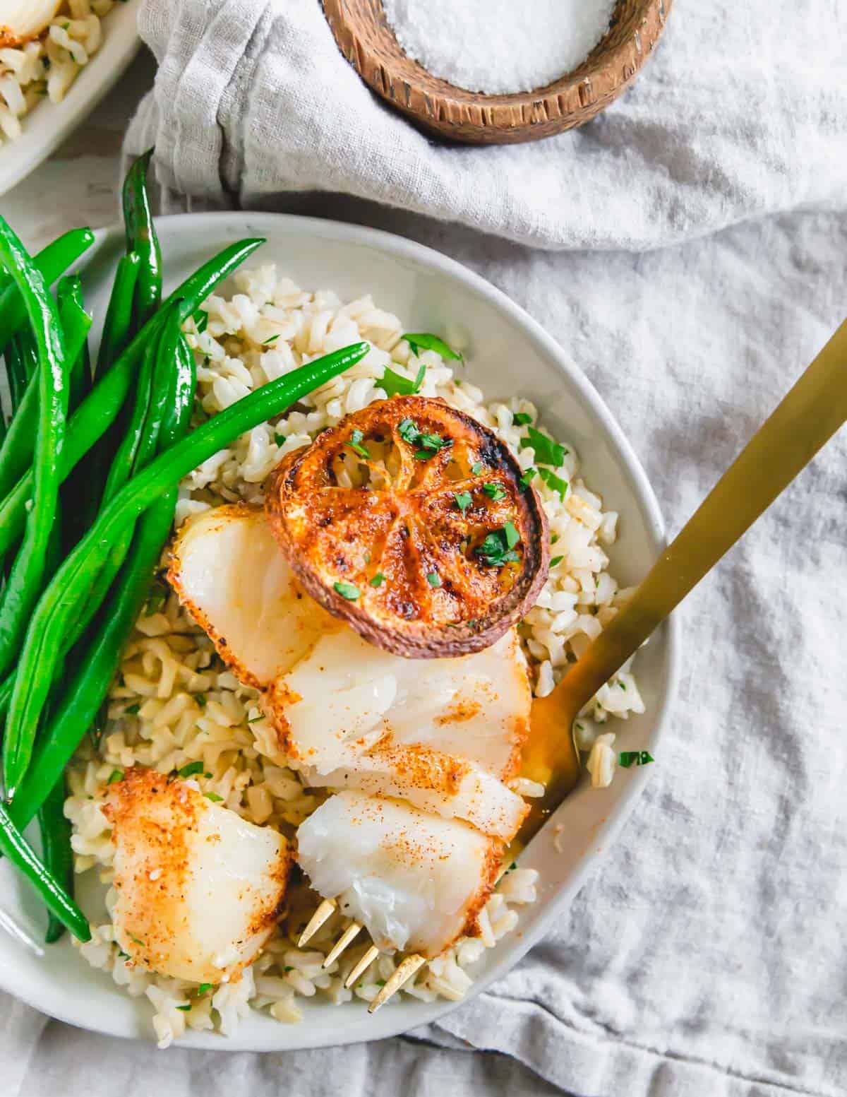 Learn how to make air fryer cod with this easy recipe using lemon and spices for a tender, delicate and delicious cod fish dinner in under 20 minutes.