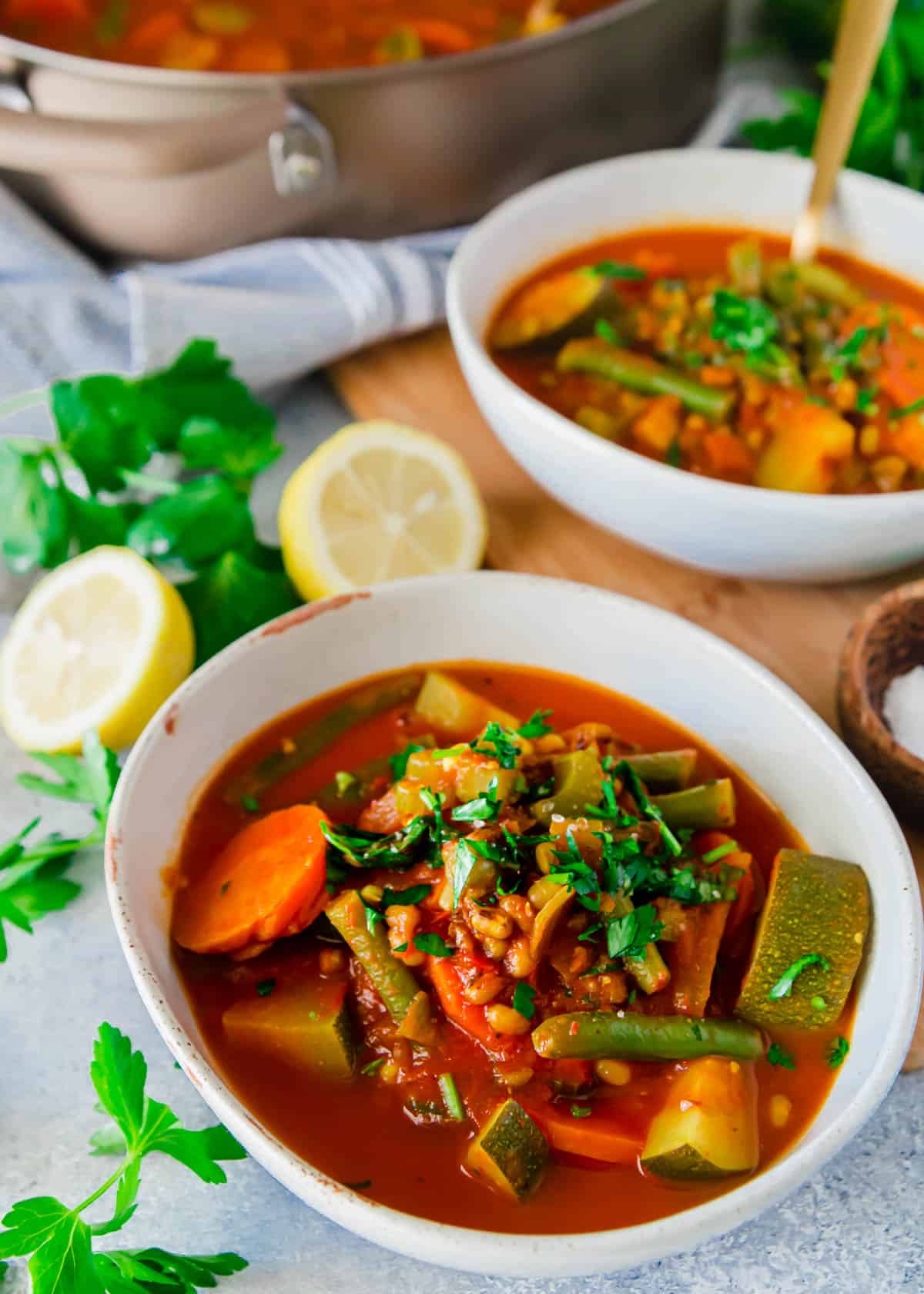 Mung bean soup with vegetables and lemon in a bowl.