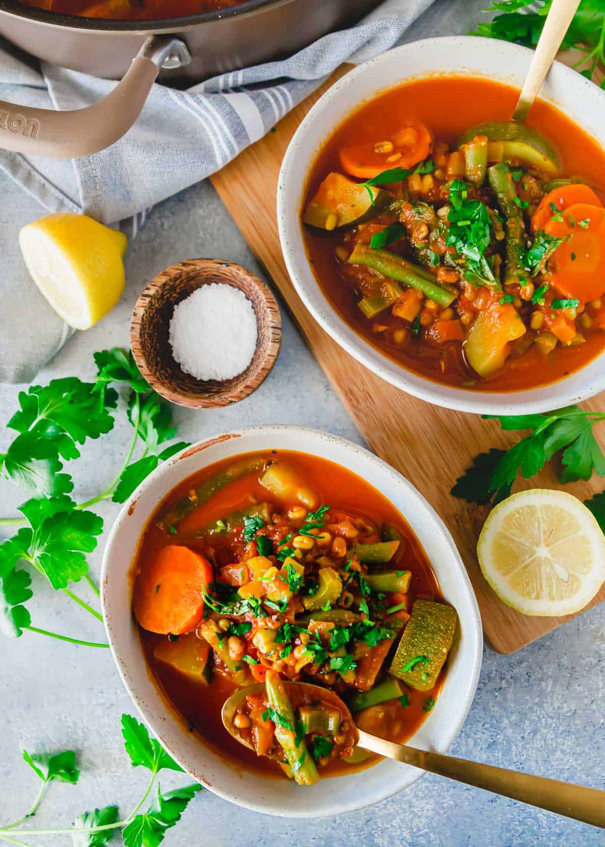 Cooked mung bean soup made with sprouted mung beans and vegetables in a bowl with a spoon.