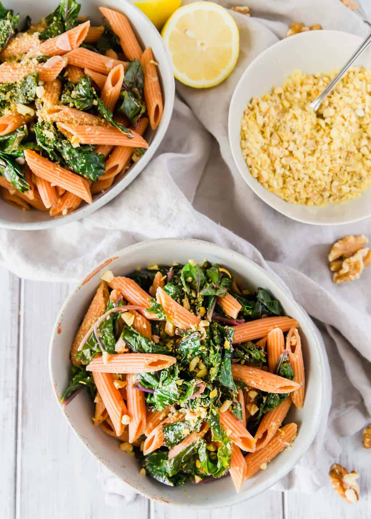 This easy red lentil pasta recipe includes sautéed garlicky lemon kale and a vegan walnut "cheese" topping.