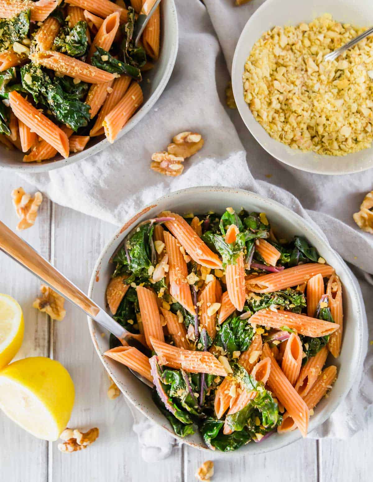 In under 30 minutes this red lentil pasta dinner with garlicky lemon greens is ready and on the table!