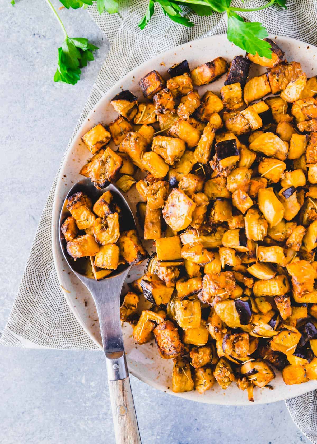 Crispy air fried eggplant cubes seasoned with simple spices on a plate.