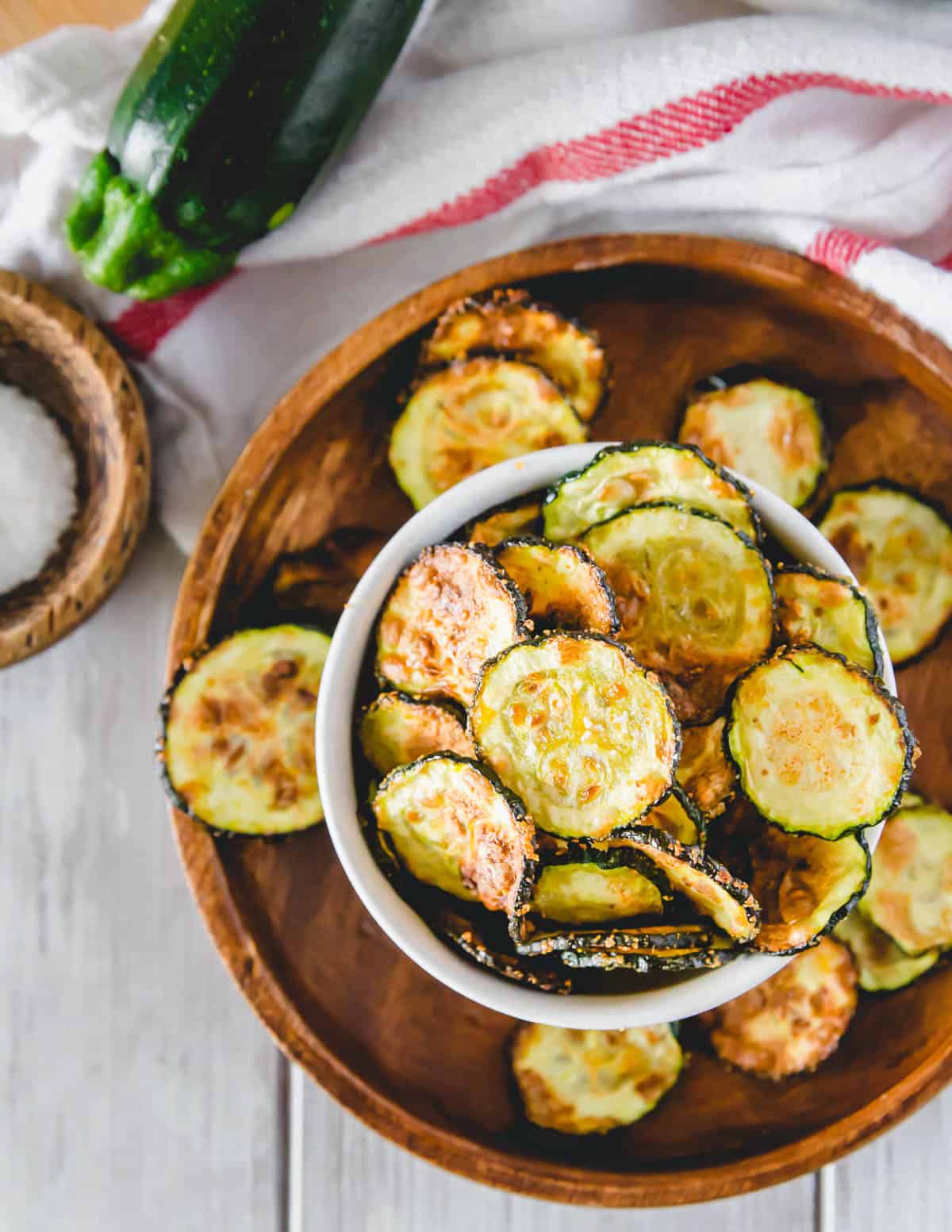 Healthy, no-breaded zucchini chips made in the air fryer with garlic seasoning in a serving bowl.