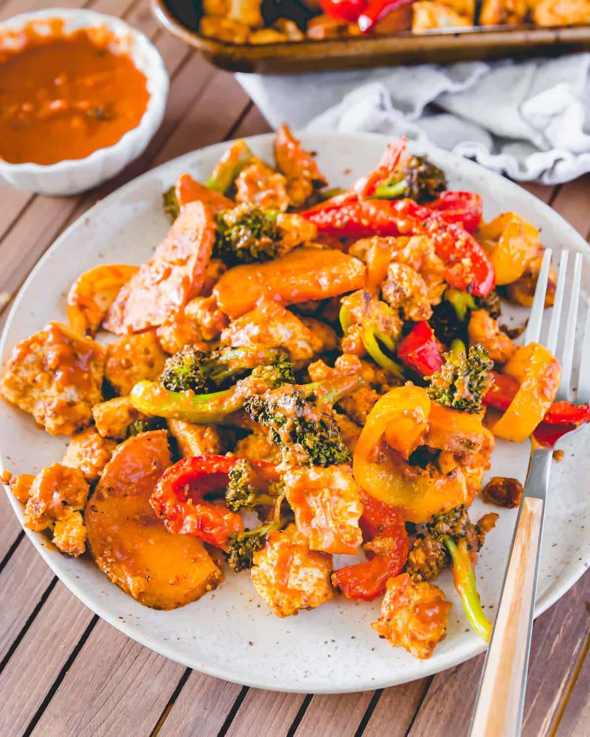 An easy plant based dinner featuring BBQ tofu with vegetables made on a sheet pan in the oven.