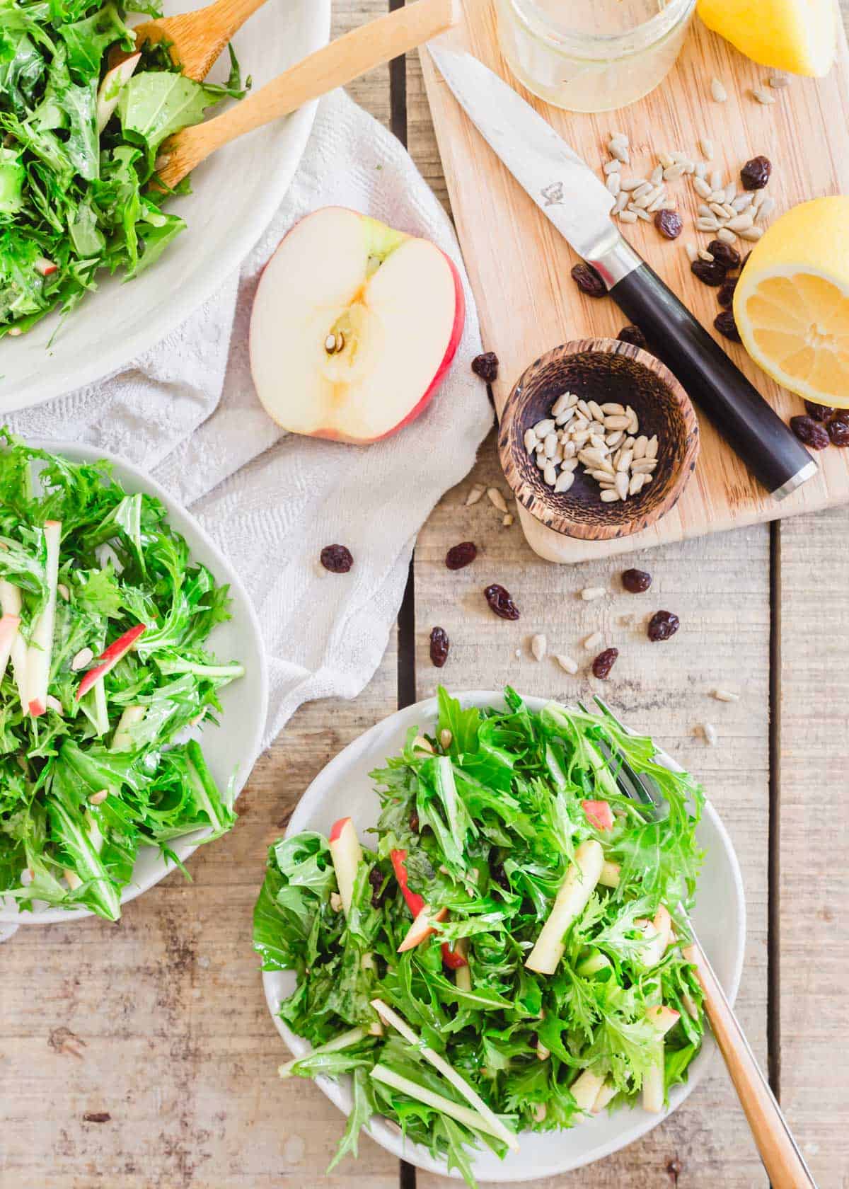 Mizuna greens salad with honey lemon dijon dressing on serving plates.