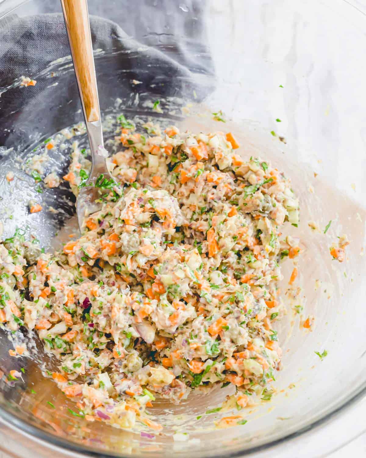 Sardine salad mashed together in a glass bowl before serving.