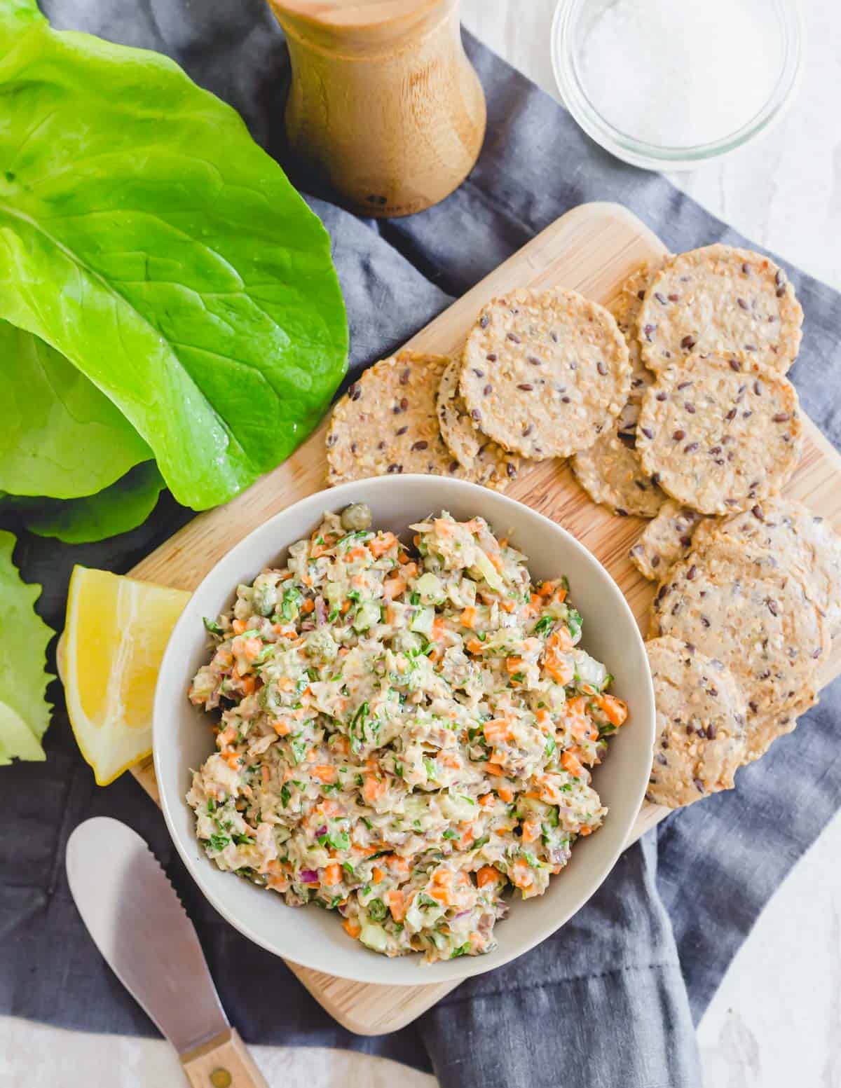 Simple sardine salad recipe in a bowl served with crackers on the side.