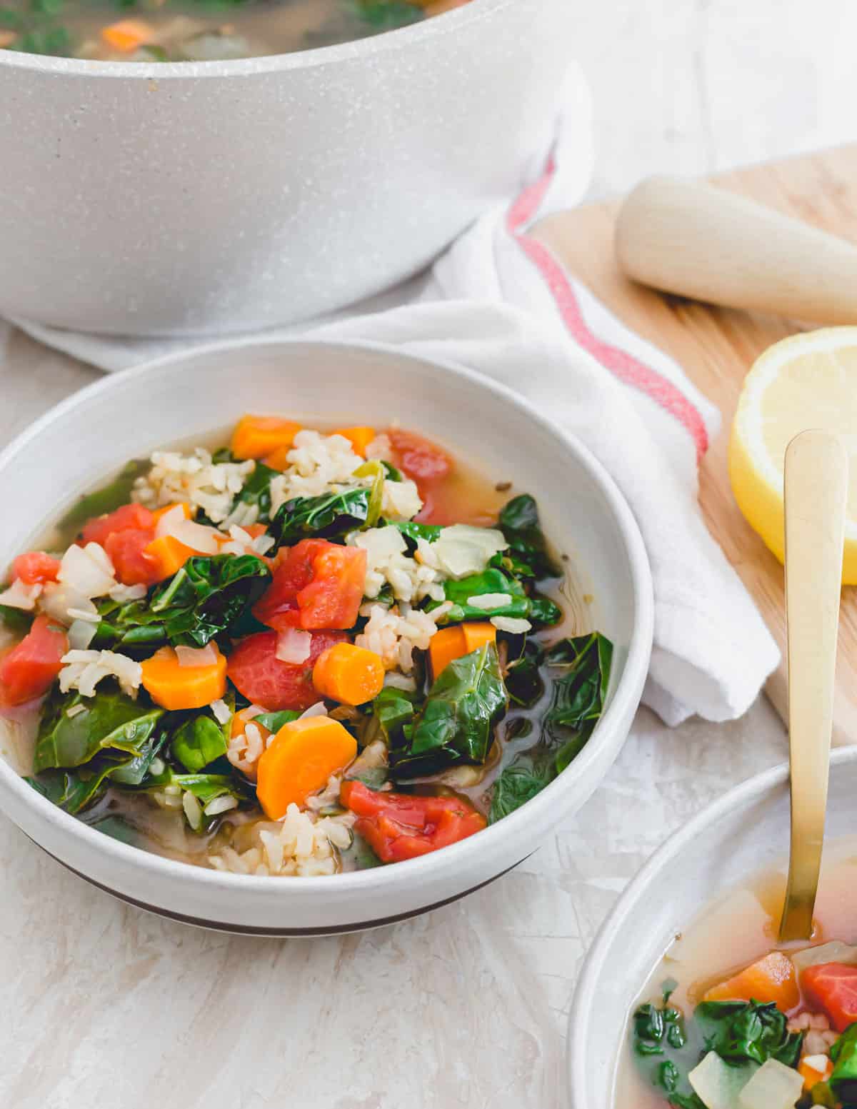 Vegetarian Tuscan kale soup with brown rice in a serving bowl.