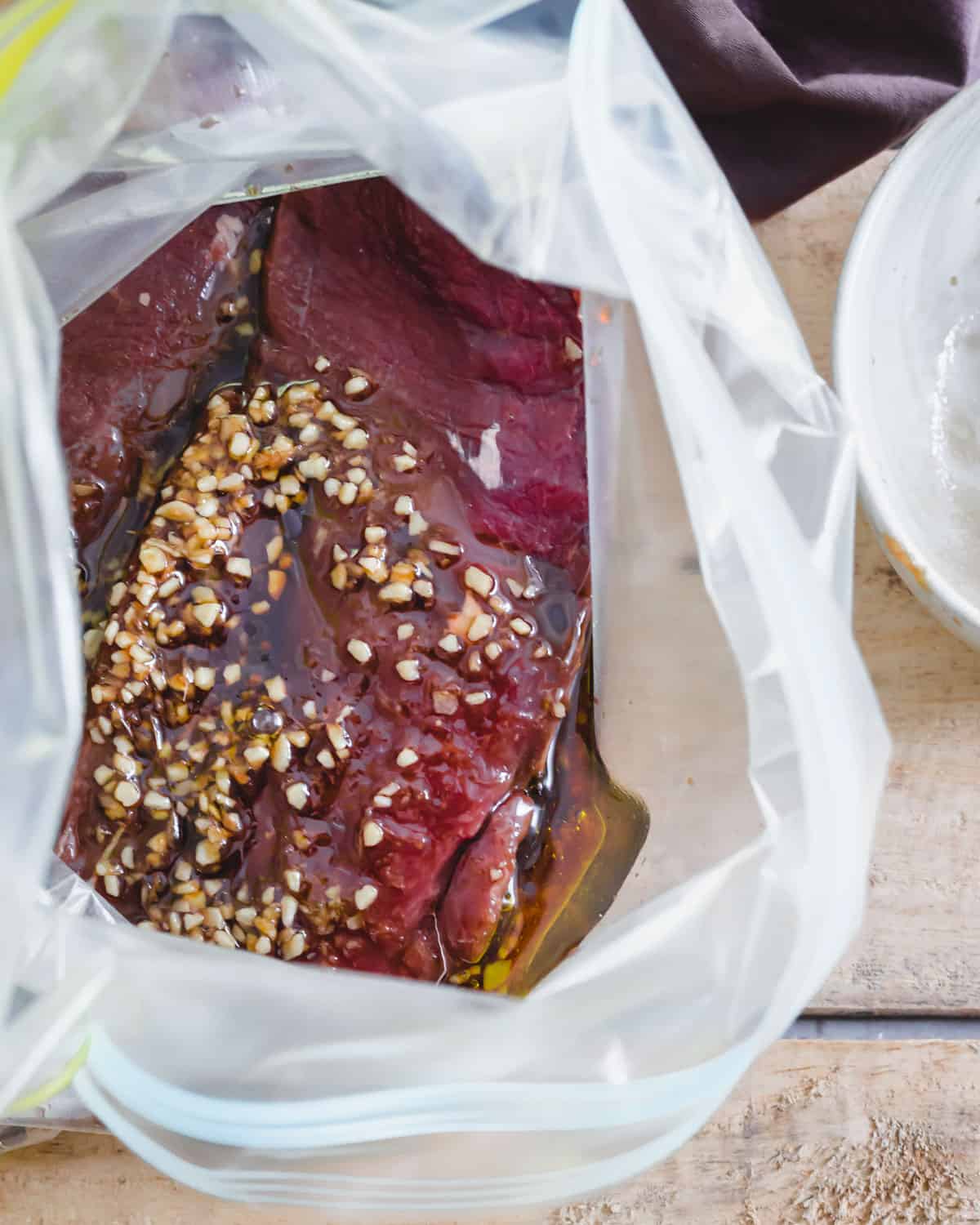 Venison backstrap marinating in a plastic bag overnight.