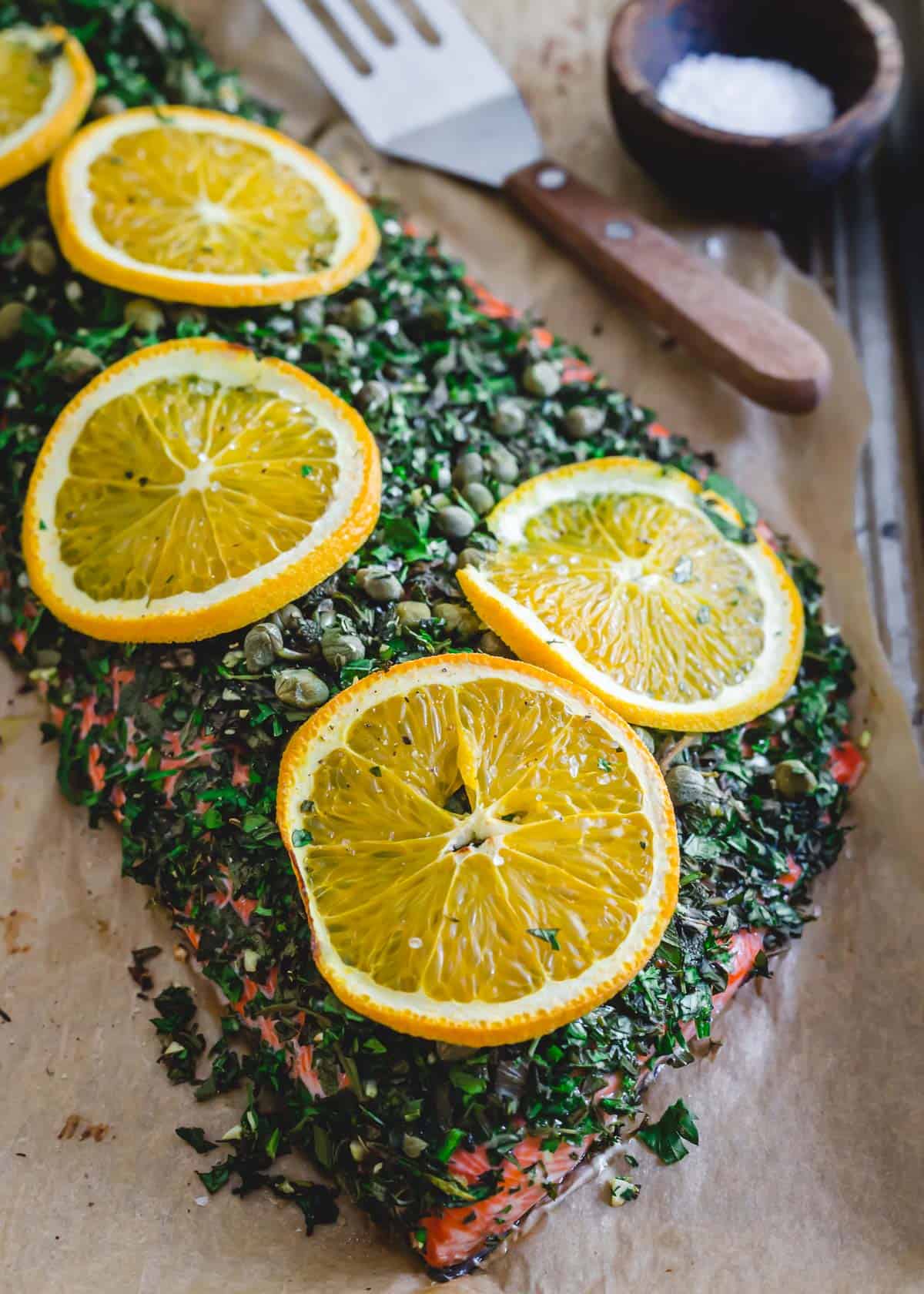 Baked sockeye salmon recipe with fresh herbs, garlic, capers and citrus.