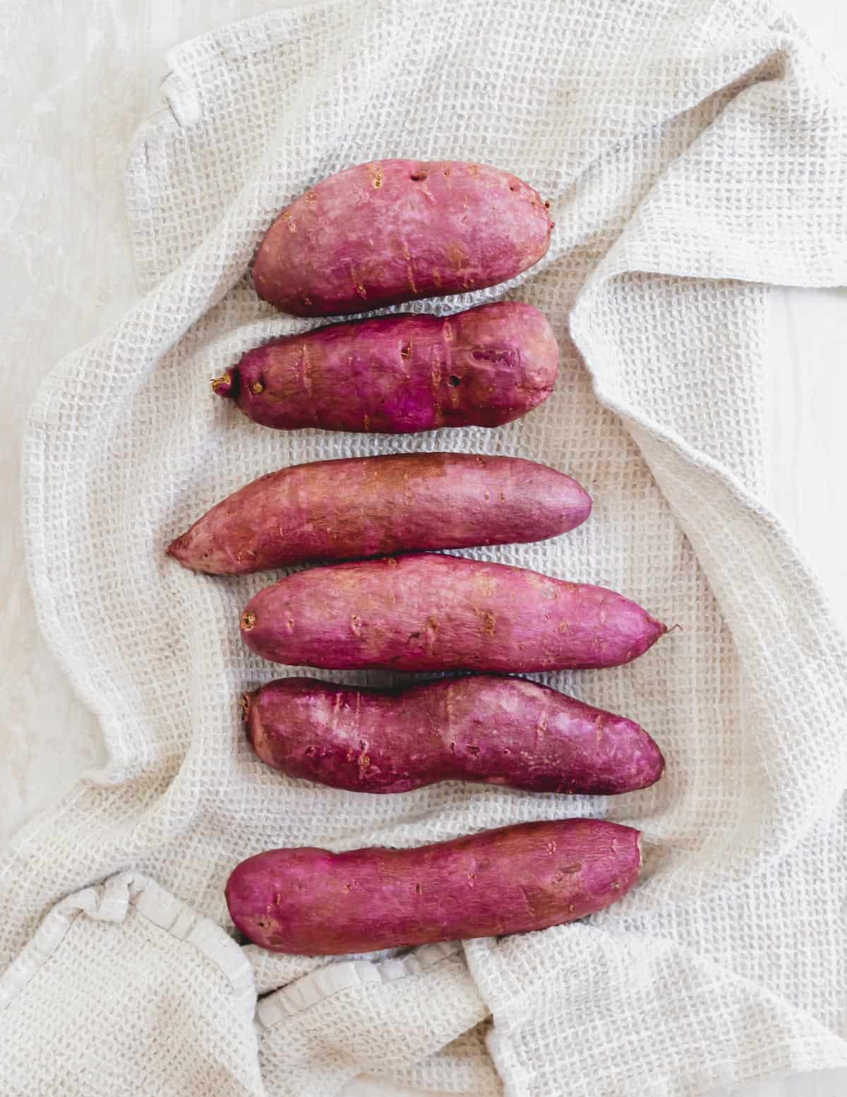 Stokes purple sweet potatoes on a kitchen towel.