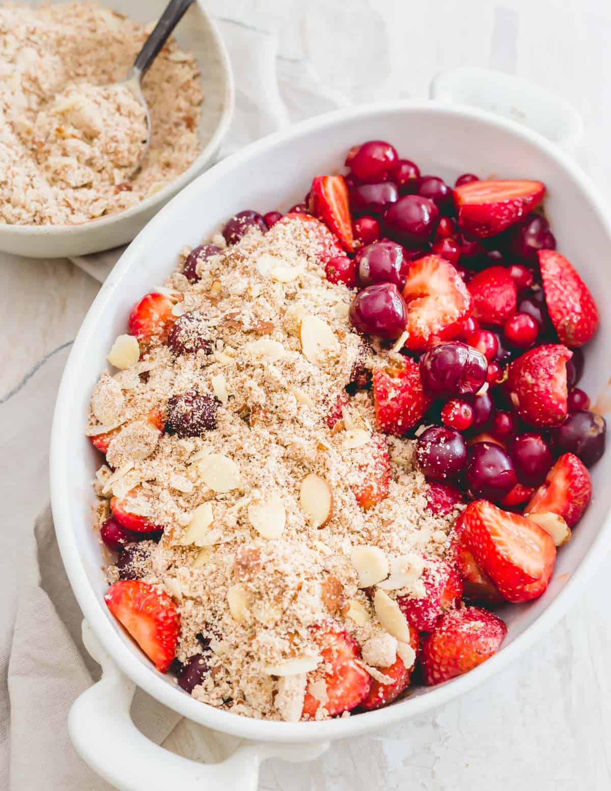 Assembling tart cherry crisp in a baking dish.