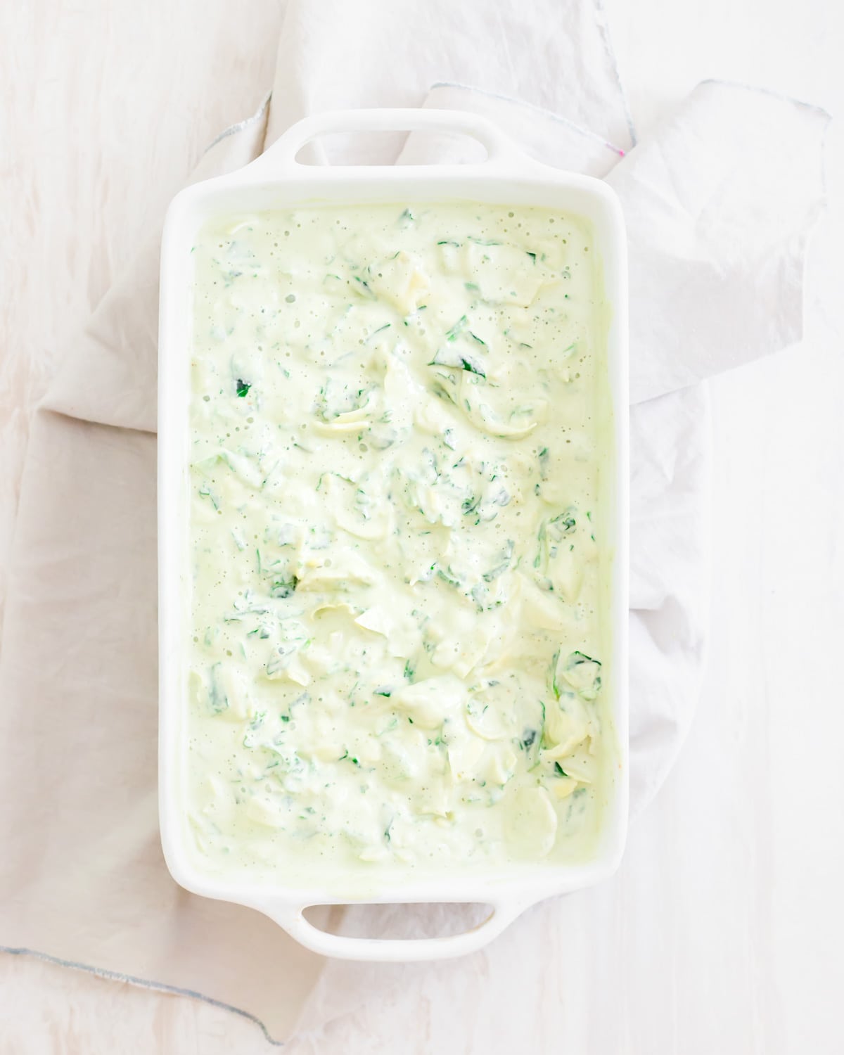 Vegan spinach artichoke dip recipe before baking in the oven.