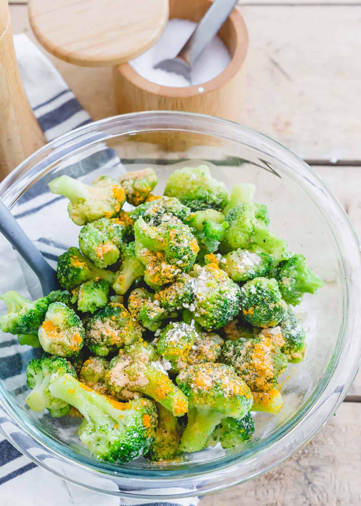Seasoned frozen broccoli florets in a bowl.