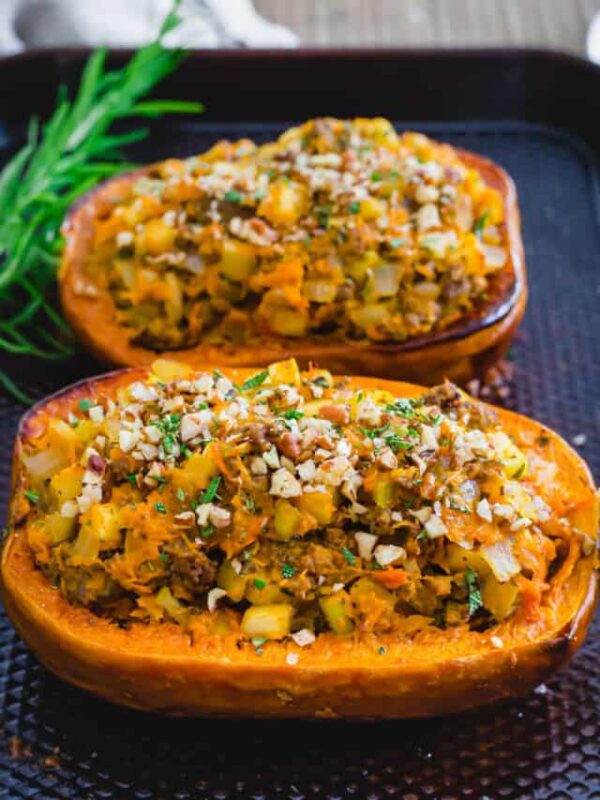 Stuffed honeynut squash on a baking sheet.
