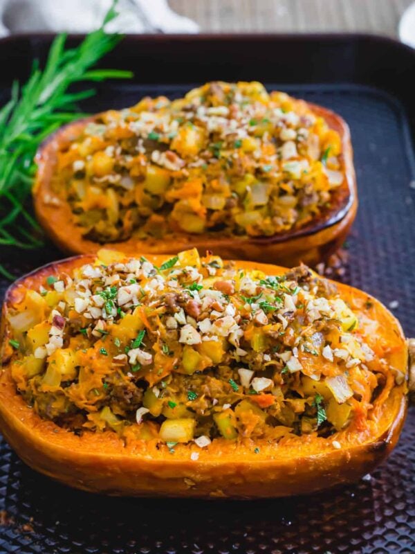 Stuffed honeynut squash on a baking sheet.