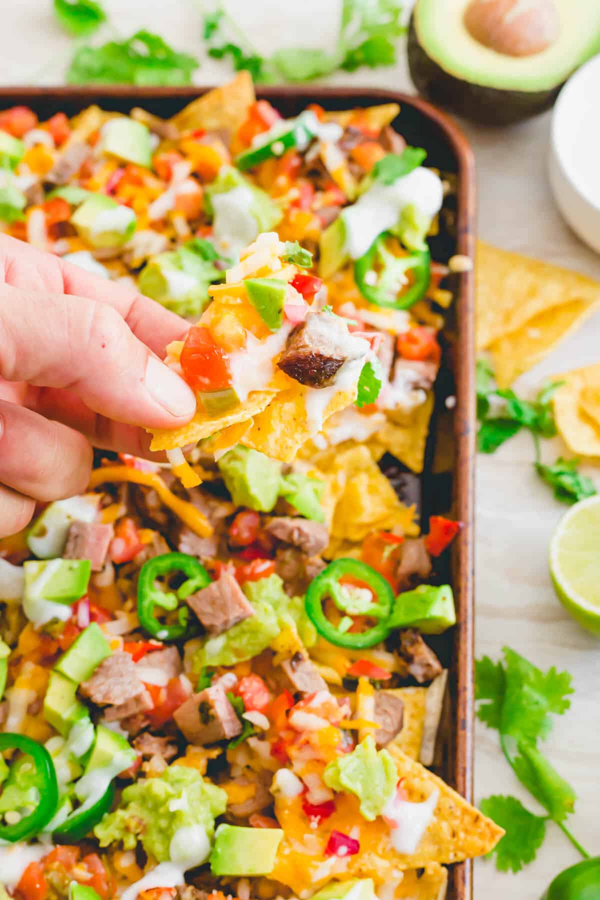 Nachos de carne asada made with marinated flank steak cooked on the grill.