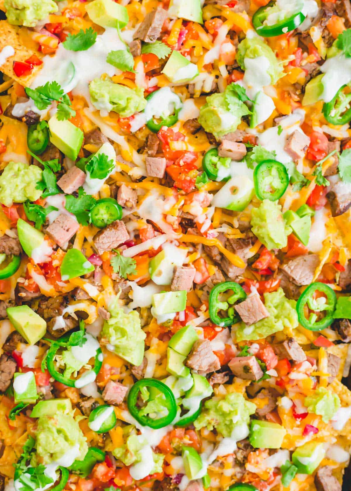 Loaded carne asada steak nachos are the perfect game day food.