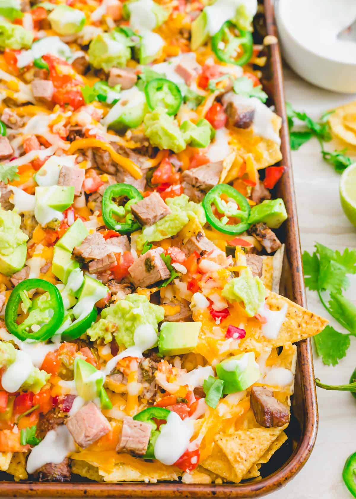 Carne asada loaded nachos with guacamole, pico de gallo, cheese, avocado, jalapeños and lime crema.