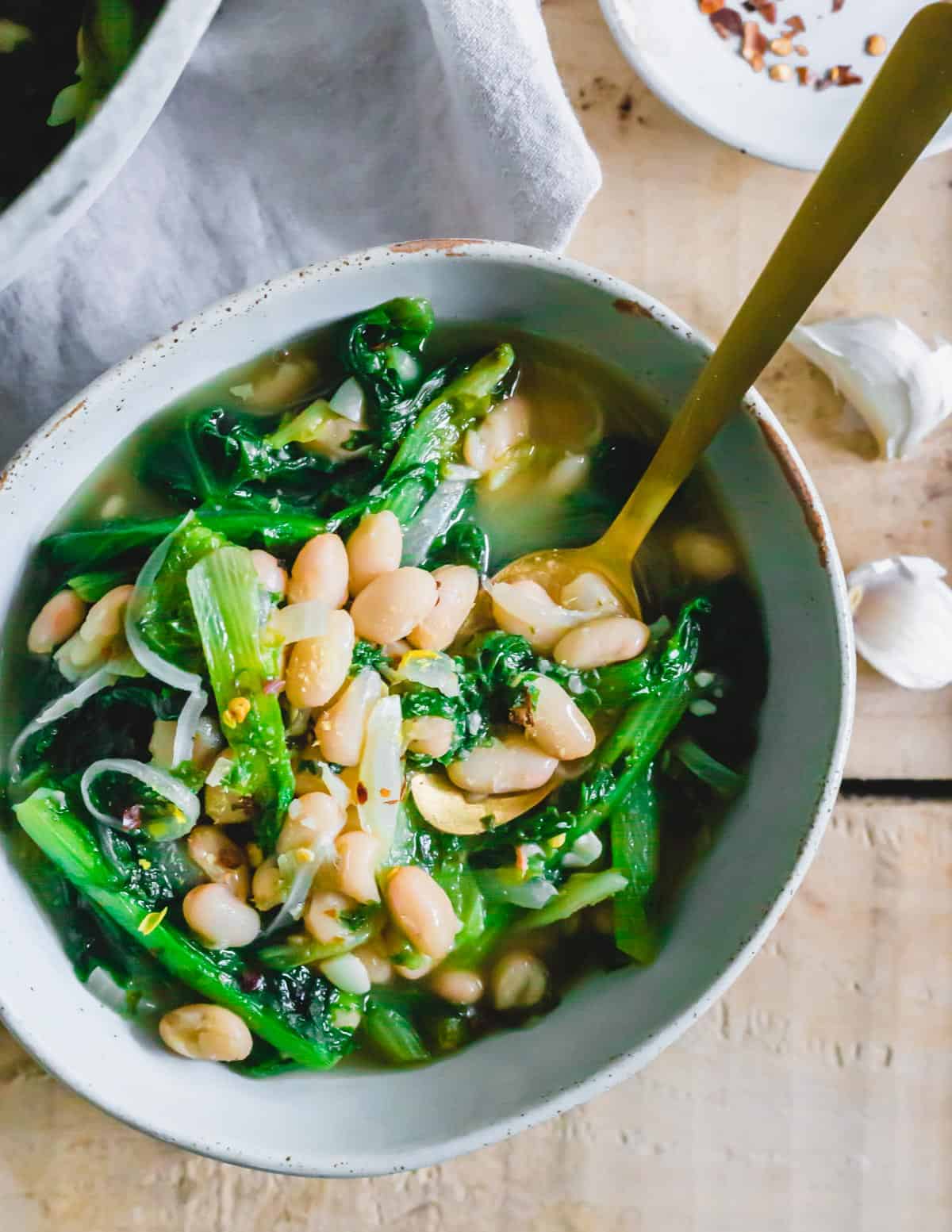 Recipe for escarole and cannellini beans in a bowl.