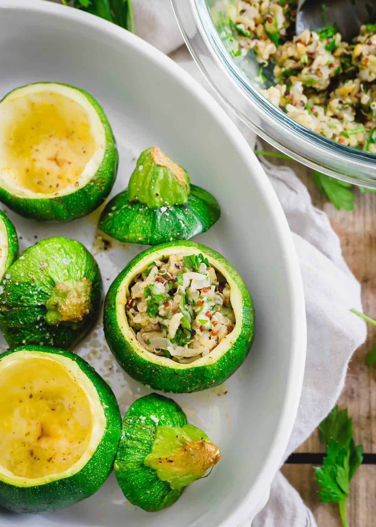 Easy recipe for baking round zucchini squash and stuffing with a vegetarian quinoa mixture.