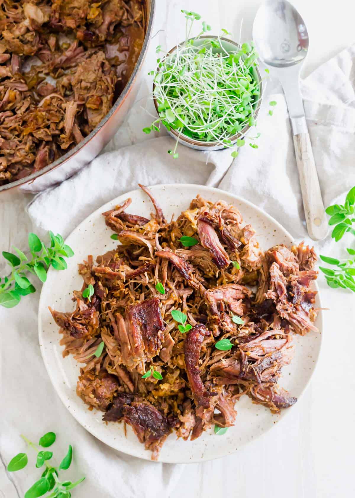 Shredded braised leg of lamb using boneless leg of lamb in Dutch oven after 3 hours.