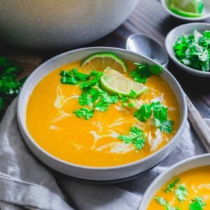 Buttercup squash soup garnished with cilantro, lime and coconut.