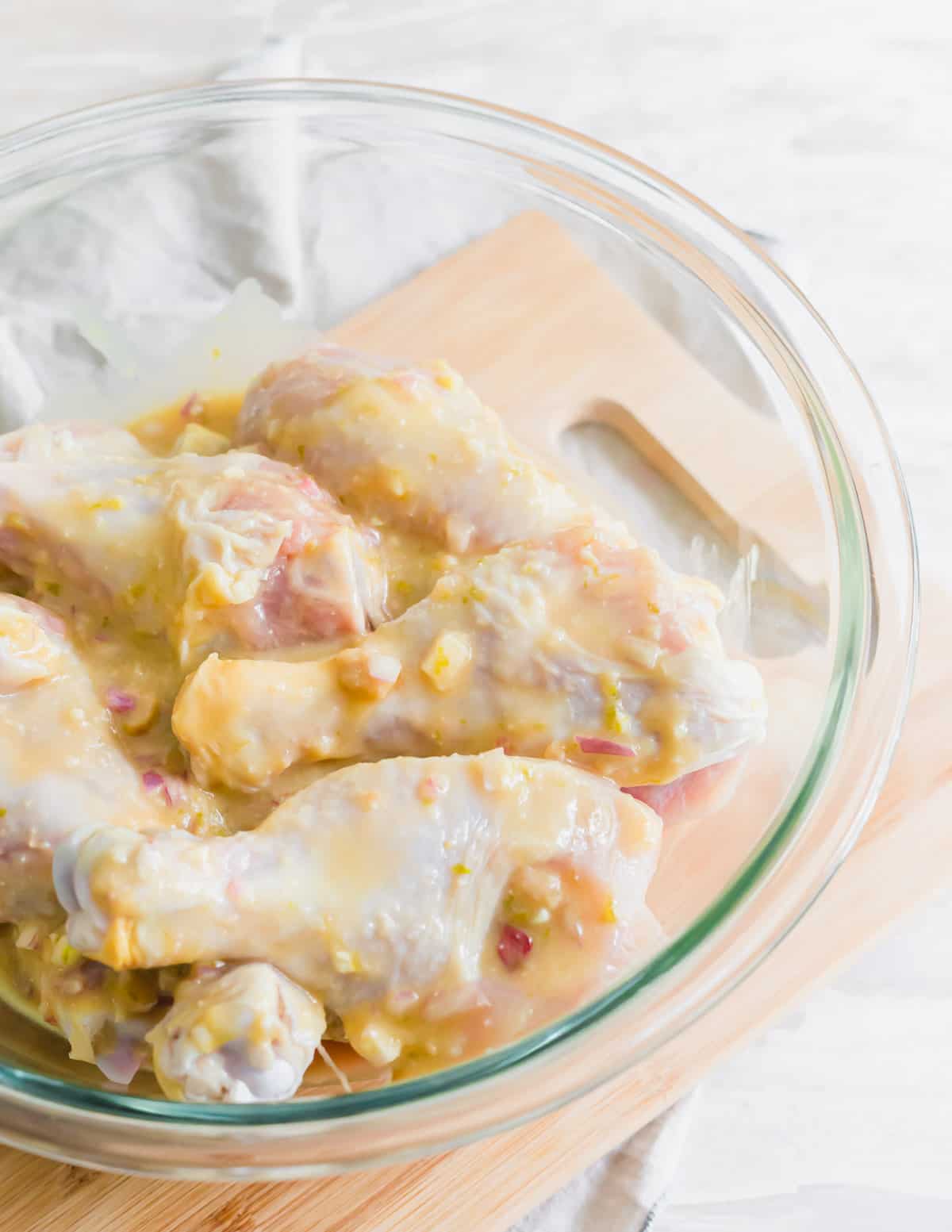Marinating chicken with miso glaze before baking in a skillet.