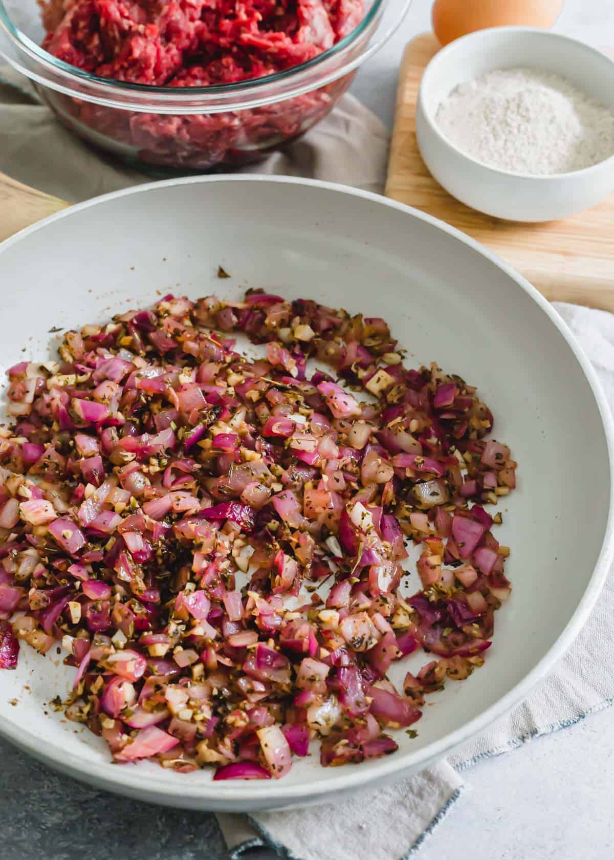 Sautéed shallots, garlic and herbs to make baked venison meatballs.