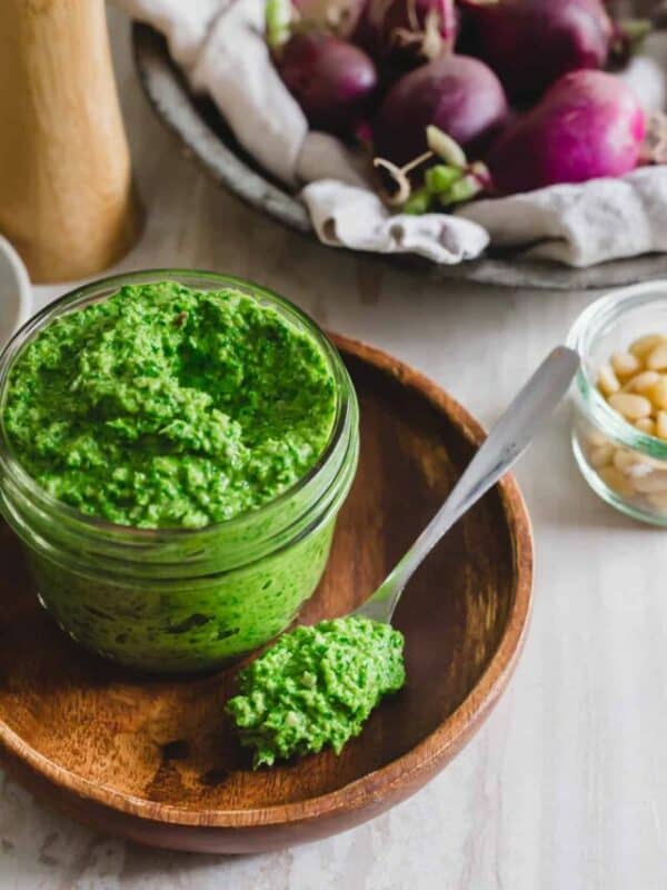 A bowl of green sauce.