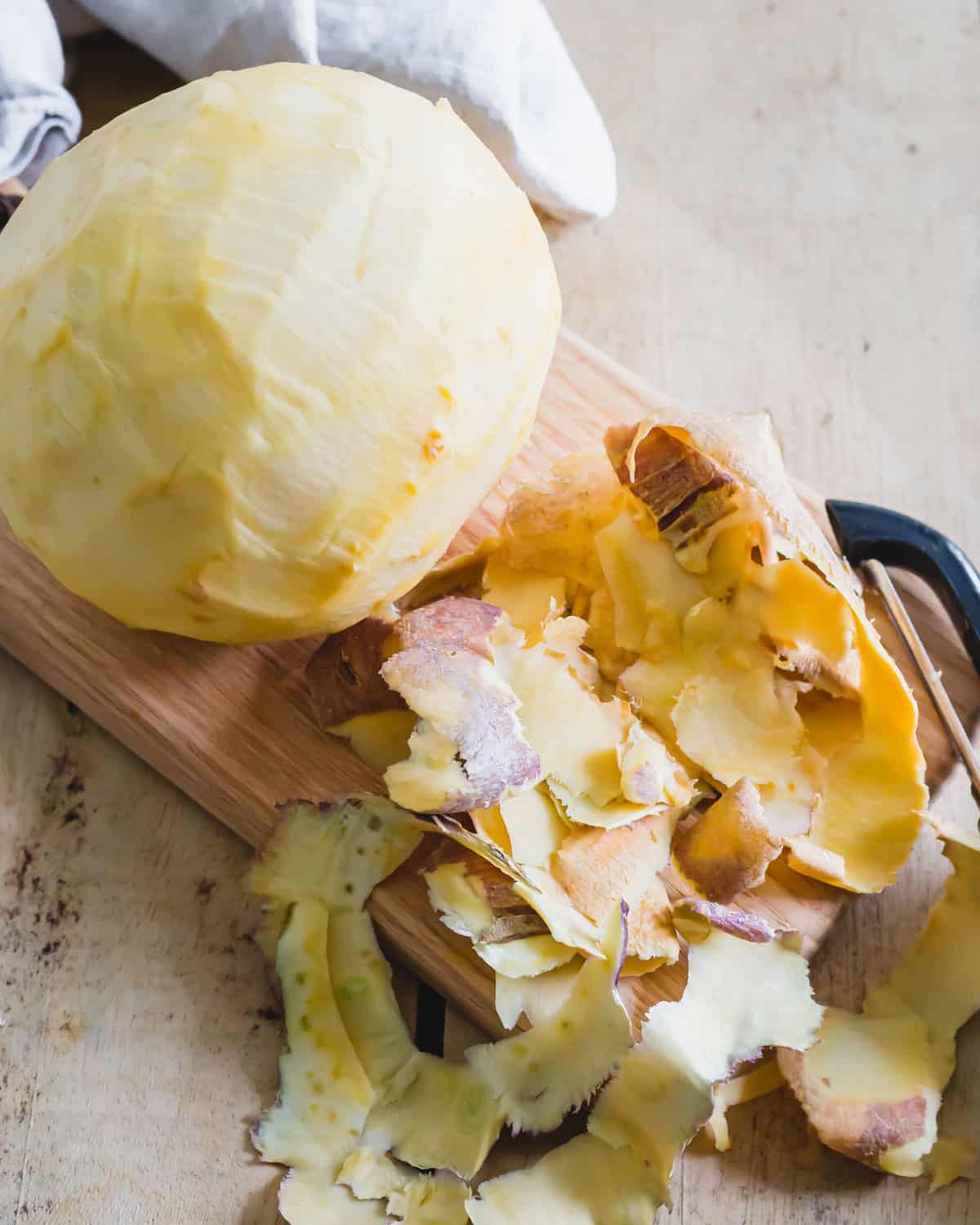 Peeled rutabaga on a cutting board.