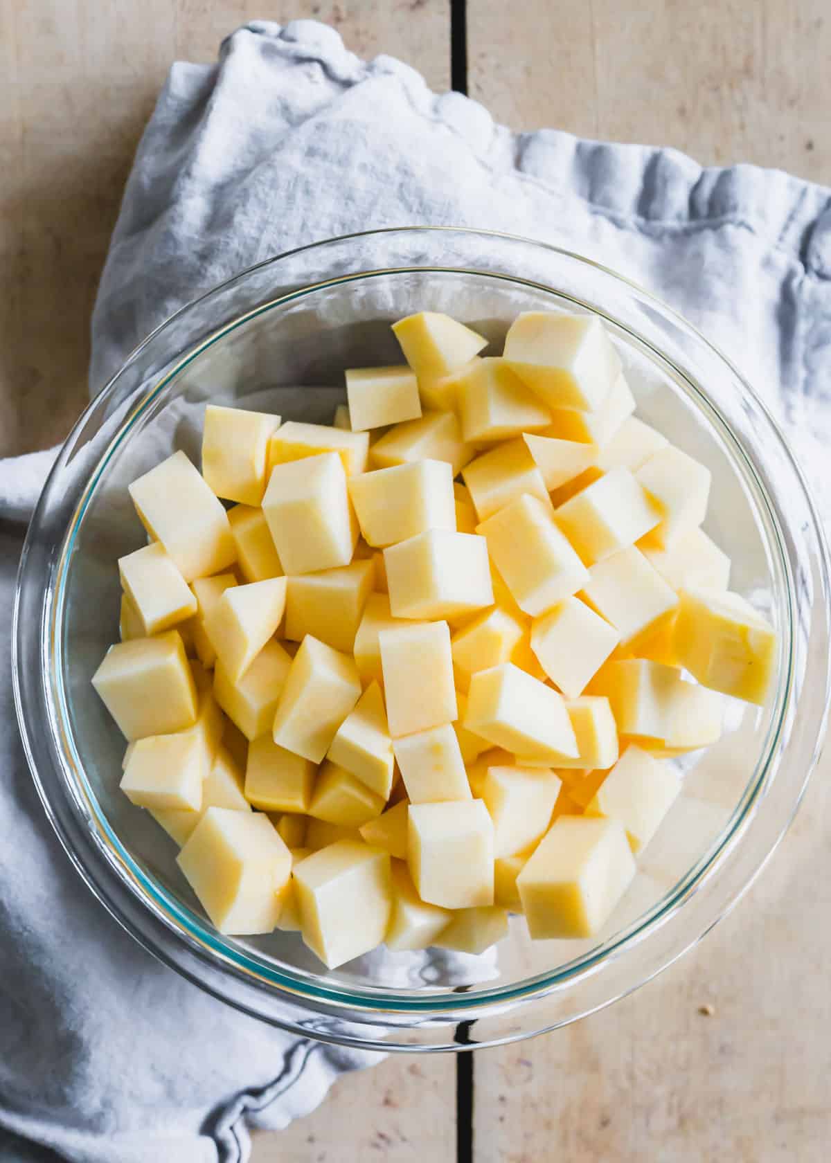 Chopped and peeled rutabaga in a glass bowl.