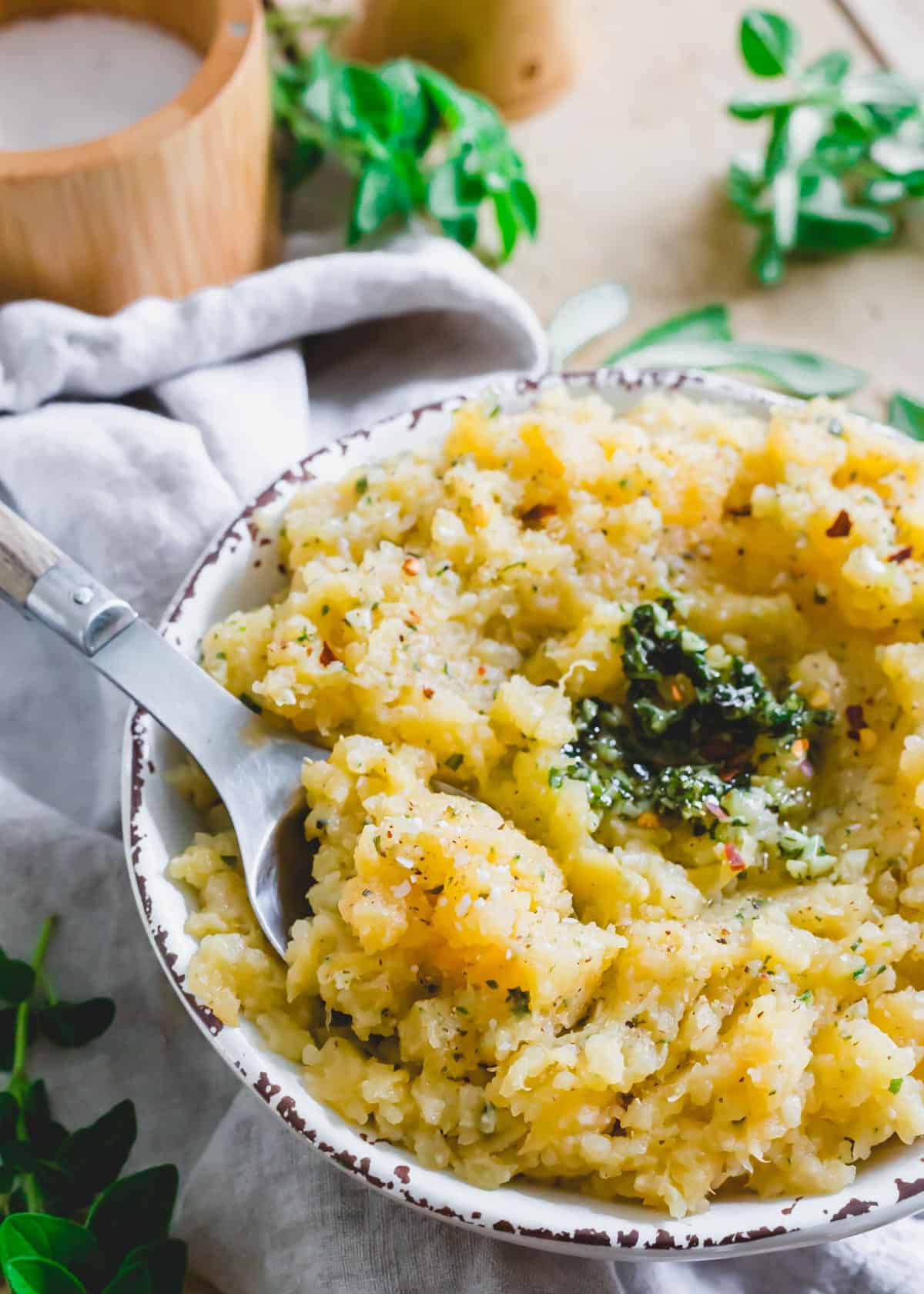 Mashed rutabaga side dish in a bowl with spoon.