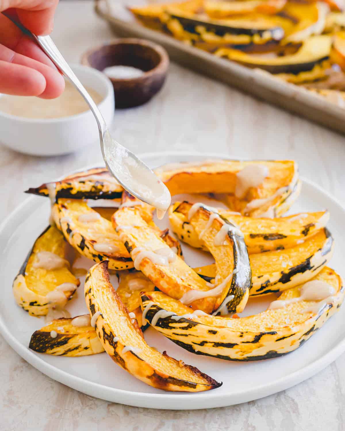 Easy roasted sweet dumpling squash recipe with serving sauce.