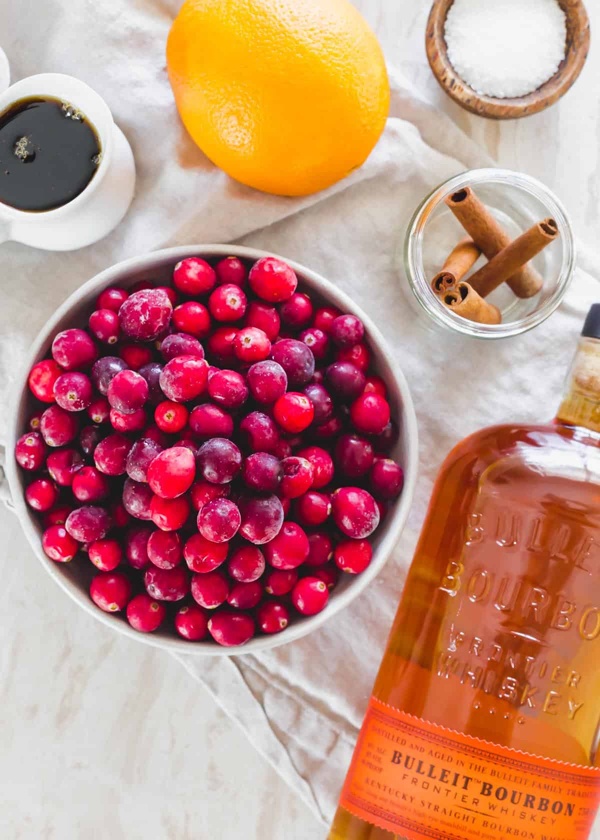 Ingredients to make cranberry sauce with bourbon.